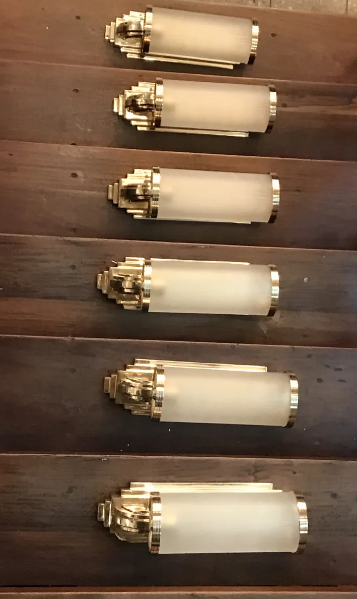 Antique sconces in gold tones and frosted glass, exquisite design.