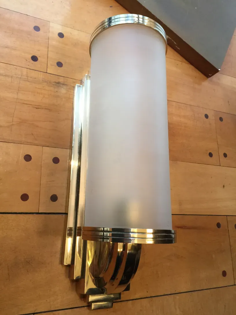 Elegant pair of antique sconces with a gold finish and frosted glass, perfect for decoration.