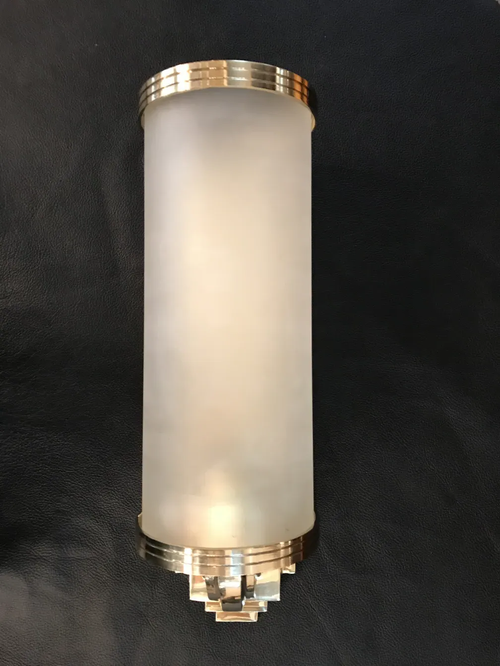 Antique pair of sconces with golden details, stylish and functional against a dark background.