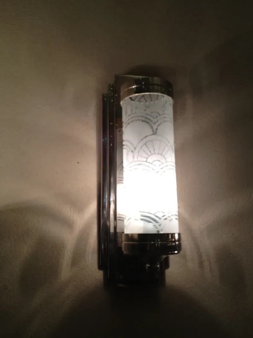 Antique pair of sconces with elegant design and warm light, decorative for any setting.