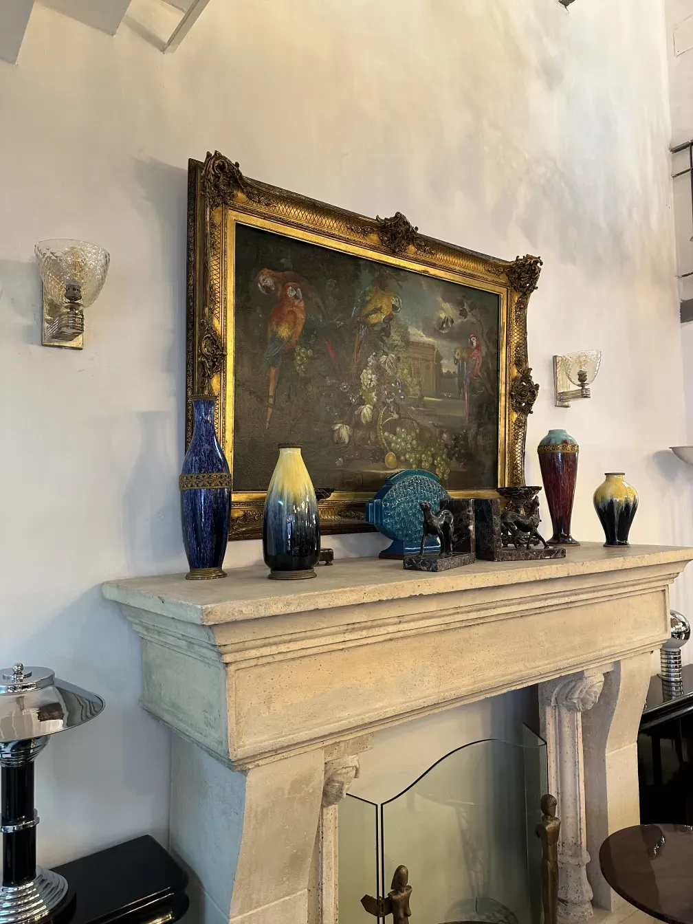 Pair of antique sconces, featuring classic decorations next to a golden frame