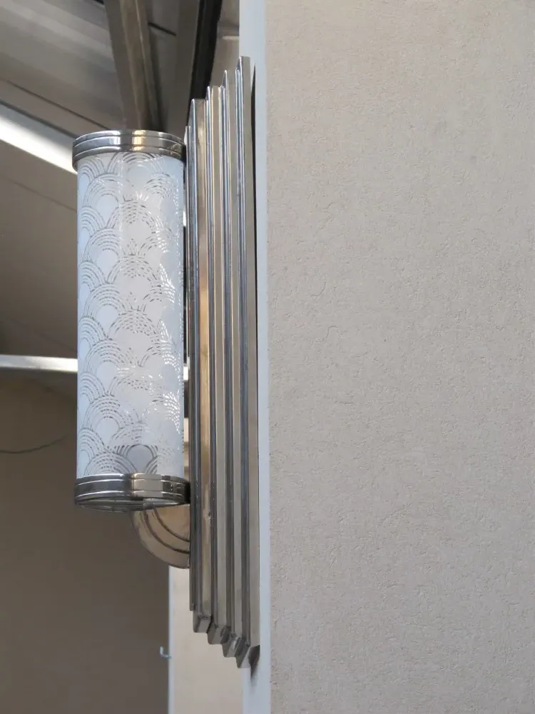 Beautiful antique pair of sconces with elegant wall design.