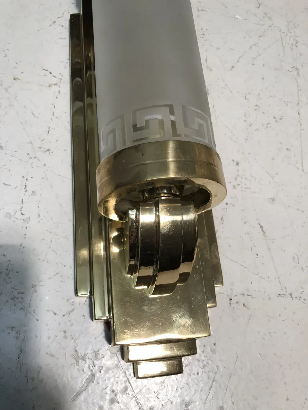 Beautiful pair of antique sconces with a golden base and elegant design.