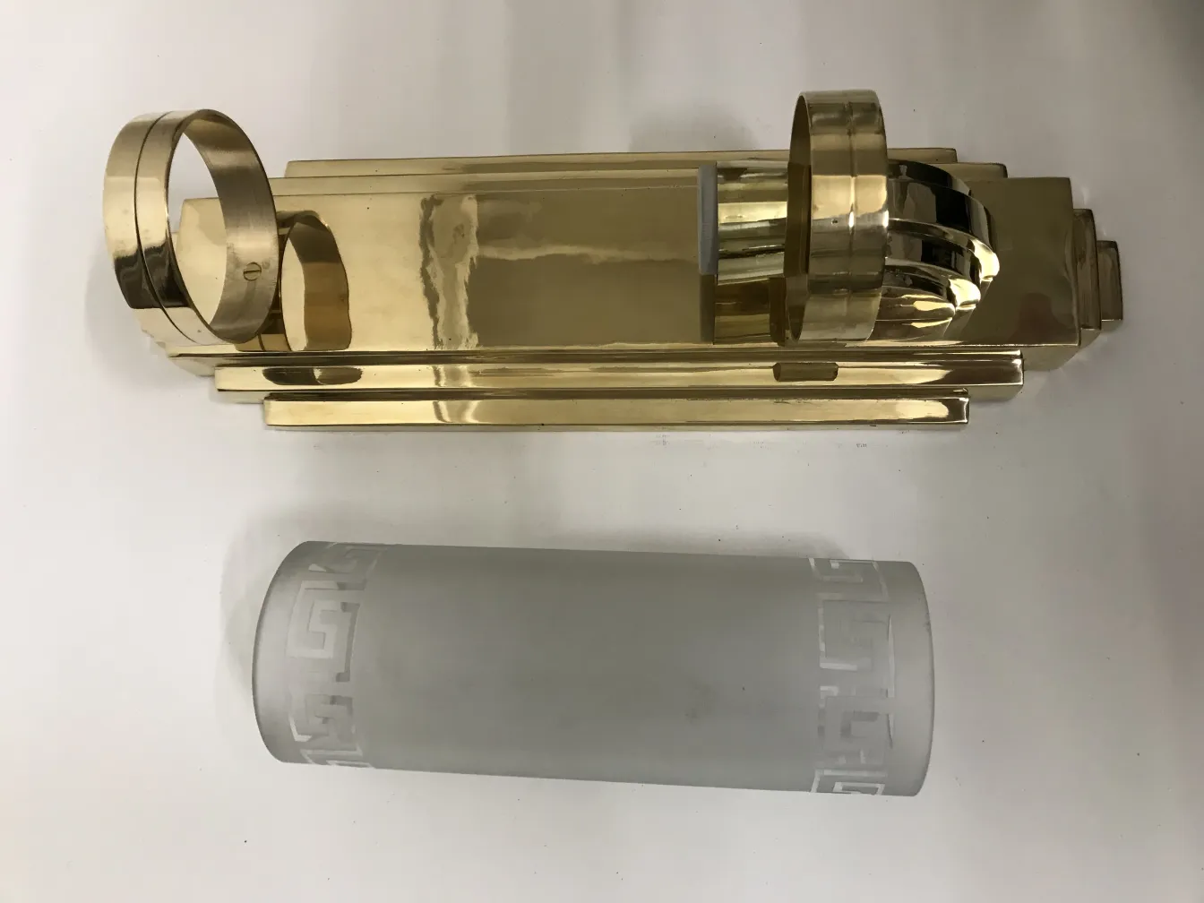 Antique pair of sconces with a gold finish and elegant features