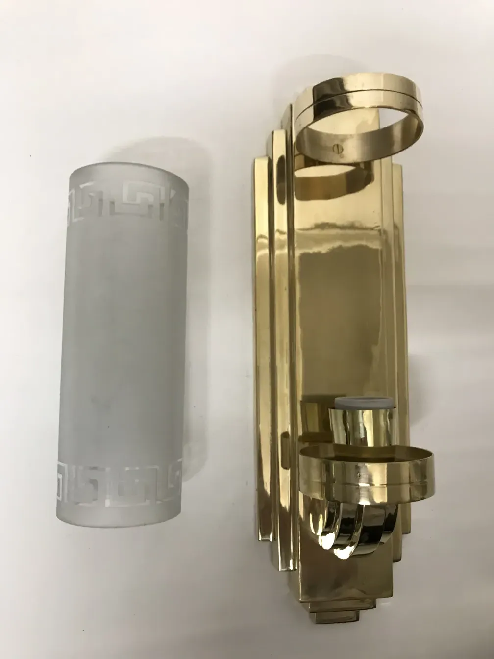 A pair of antique sconces featuring an elegant, detailed design.