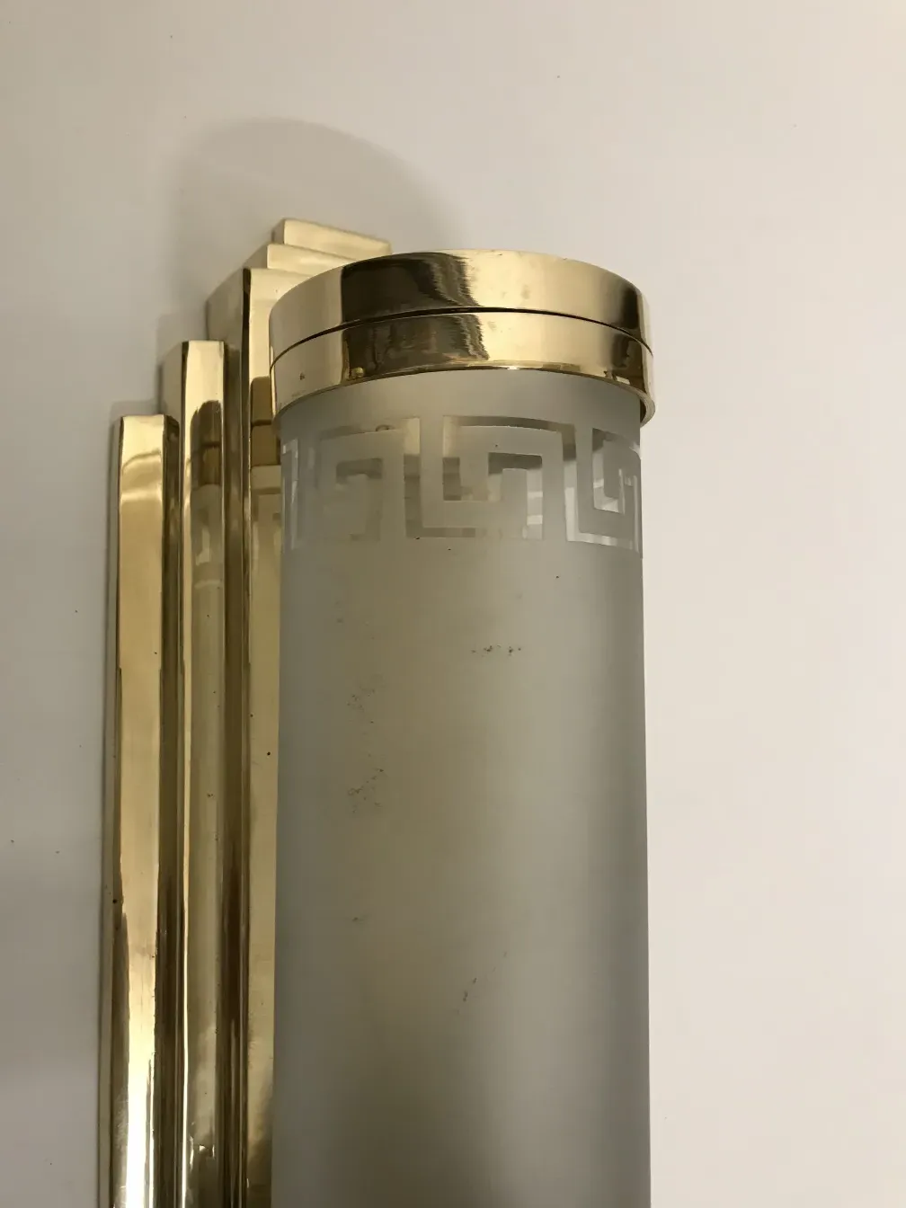 Pair of antique sconces featuring frosted glass and gold base.