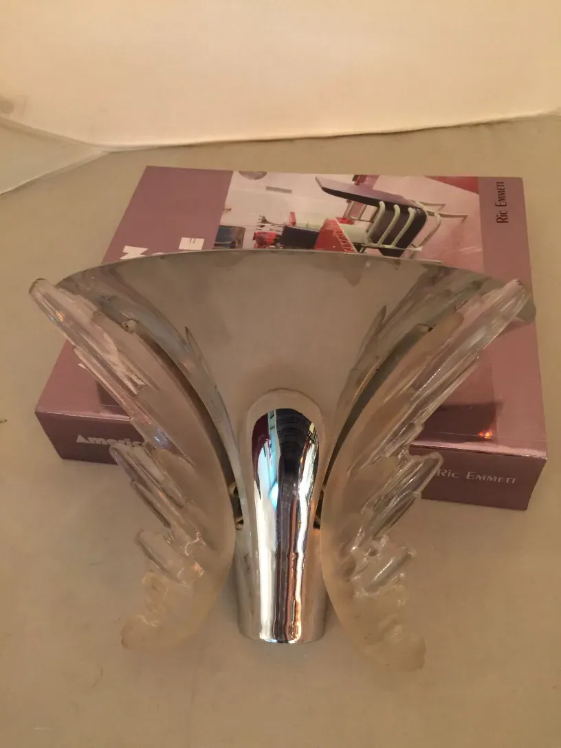 Pair of antique sconces with a unique design, featuring soft curves and shiny details, perfect for enhancing interiors.