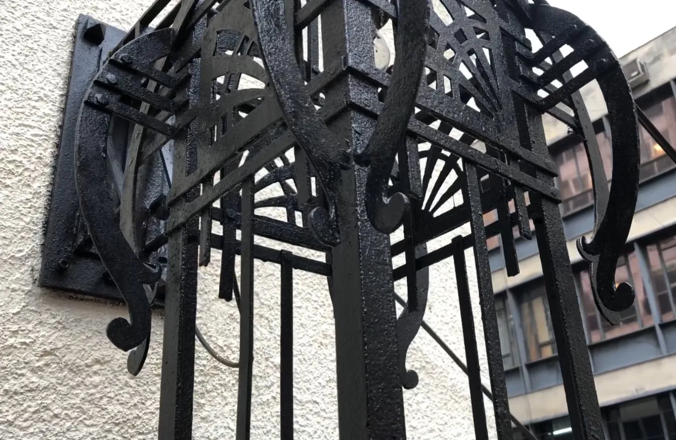 Antique decorative black metal sconce with intricate design