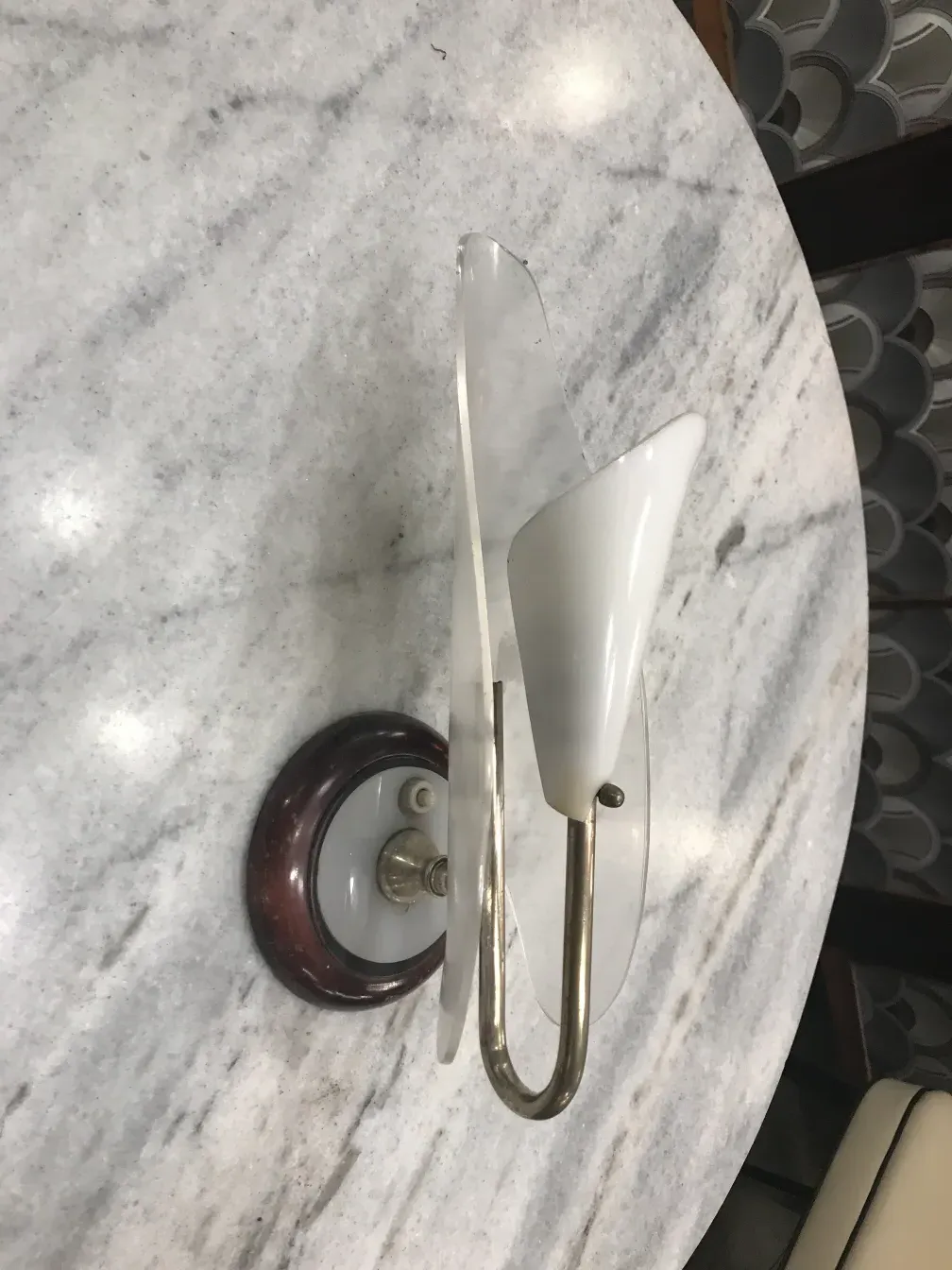 Antique sconces with elegant design, decorative base on table.