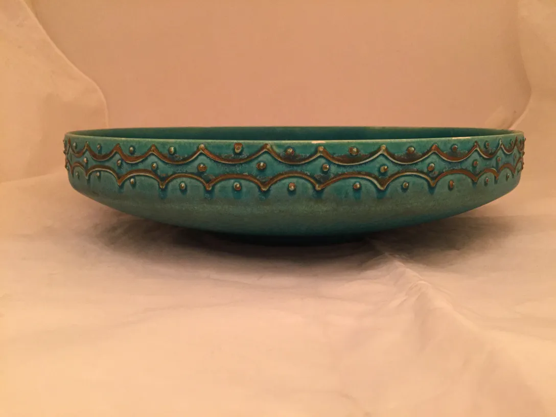 Antique turquoise ceramic bowl with embossed designs
