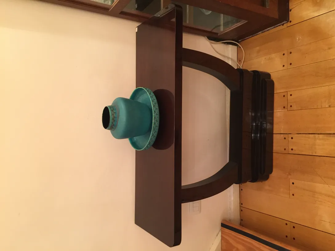 Antique turquoise ceramic on wooden table.