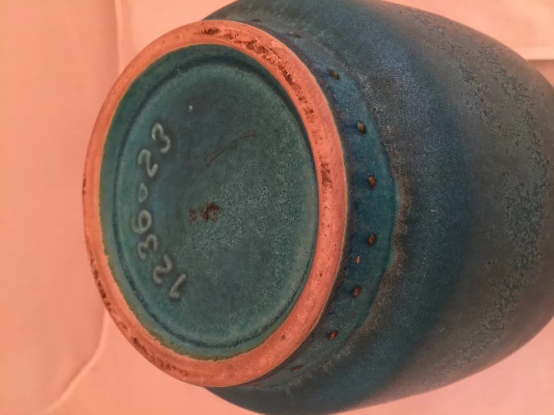View of the base of antique artisan ceramic in blue.