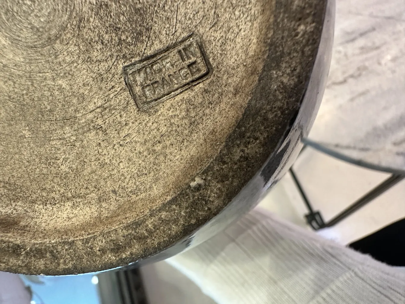 View of the bottom of an antique ceramic with a visible stamp