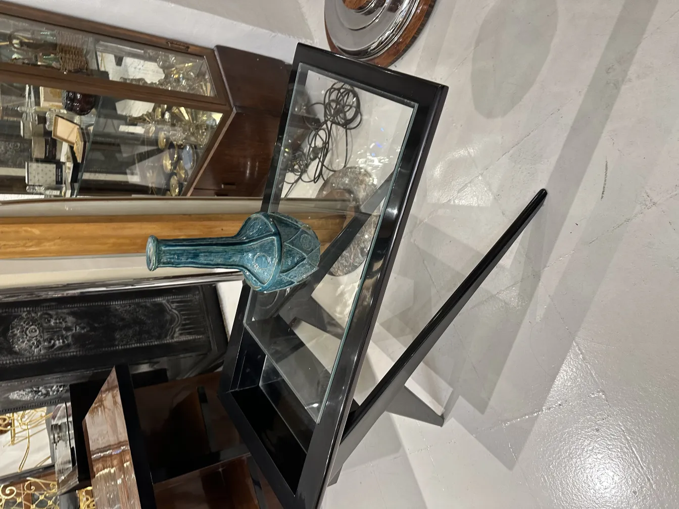 Antique blue ceramic vase on a glass table.