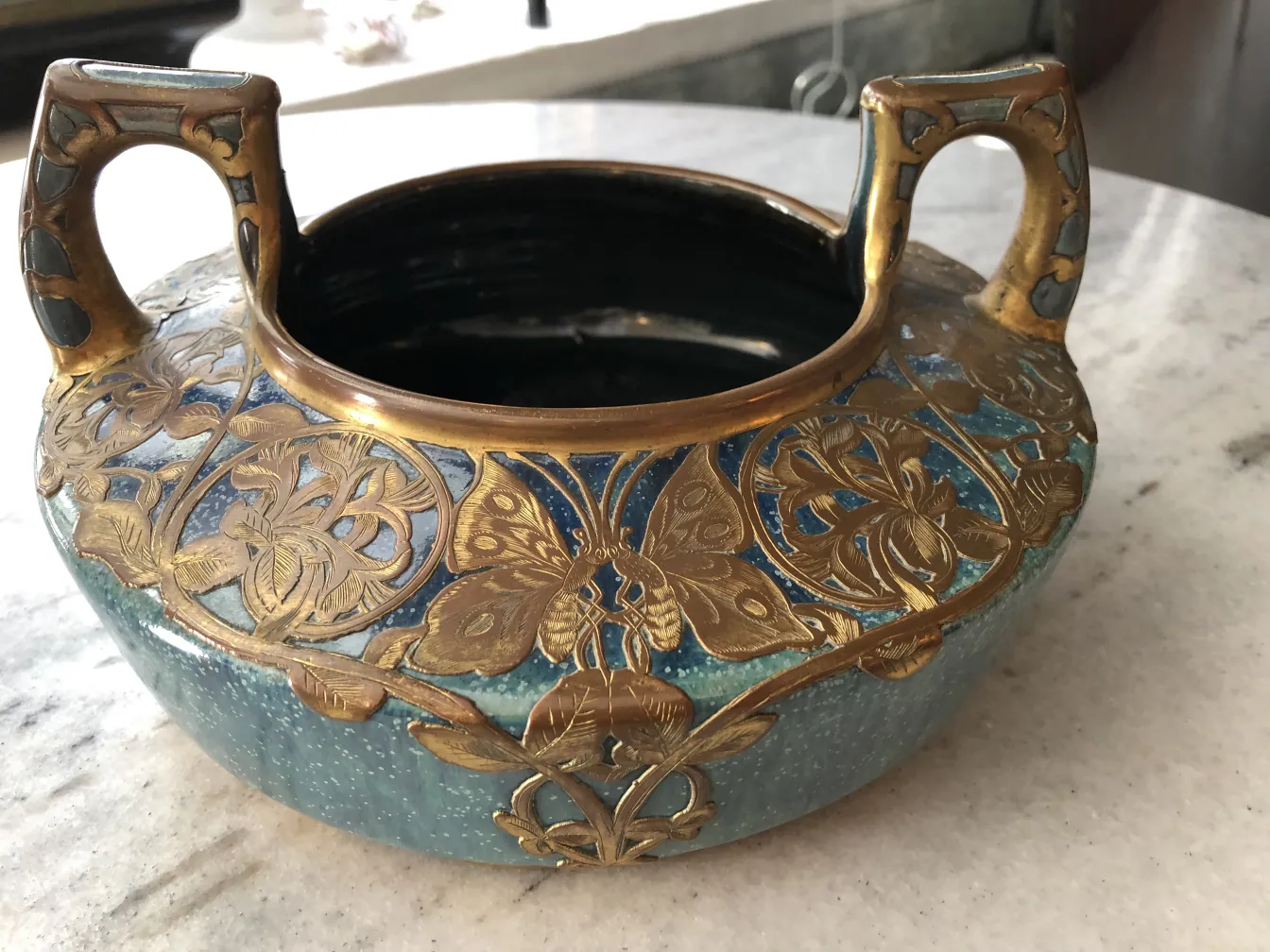 Antique decorative ceramic with handles, relief details, blue and gold.