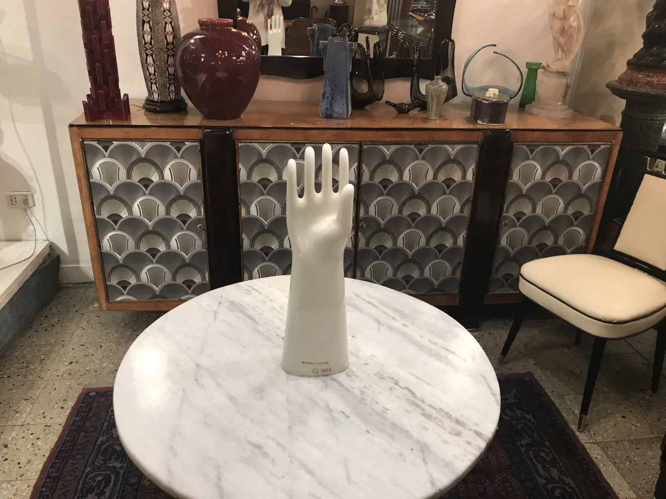 Antique ceramic decorative hand, white, in a vintage setting.