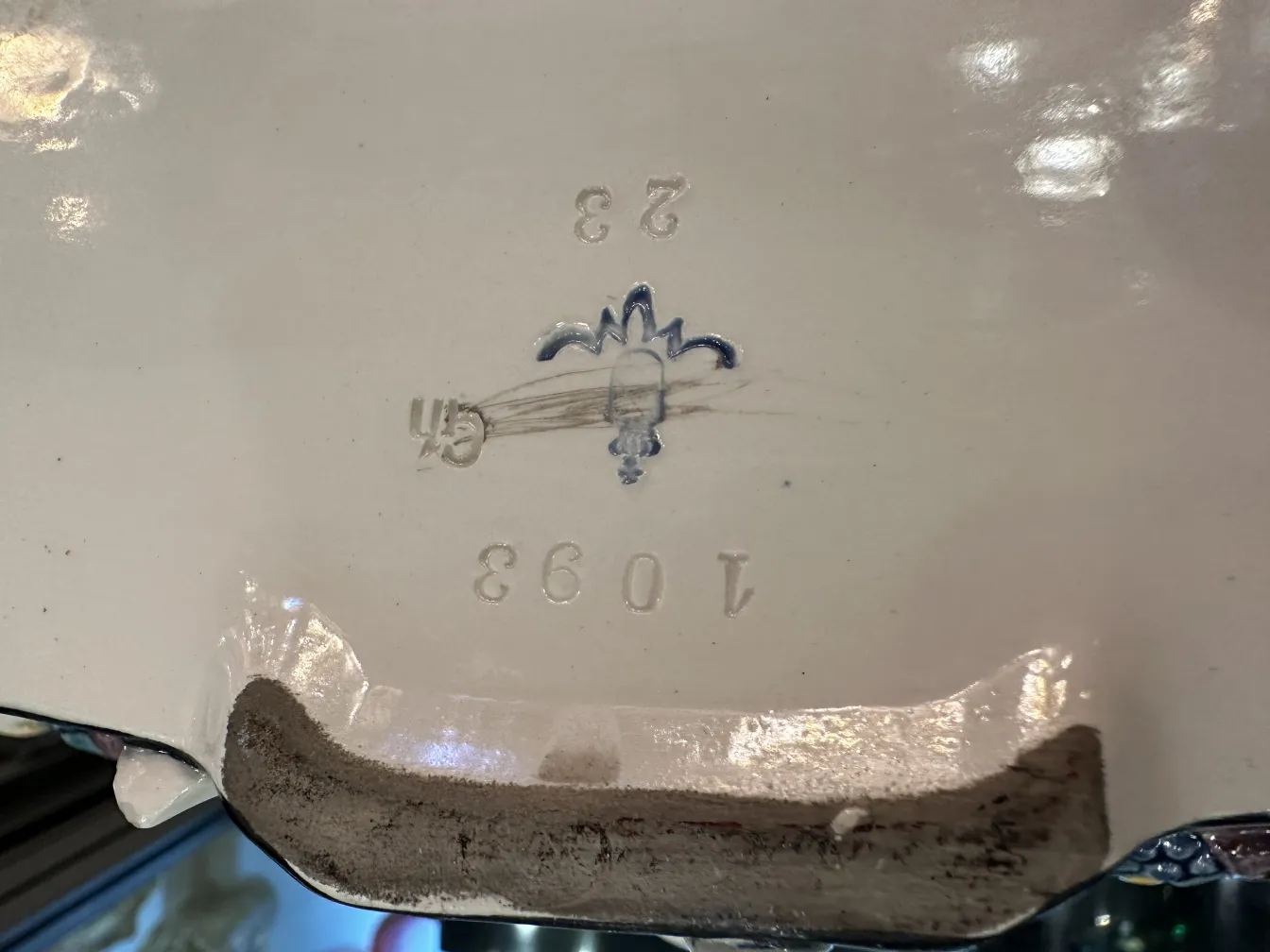 detail of ancient ceramic with fine decorations and mark