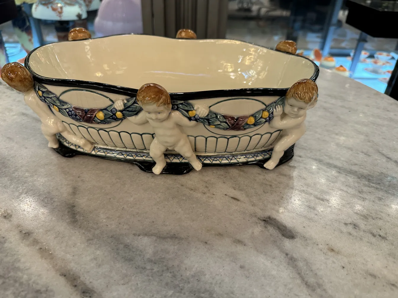 antique decorative ceramic featuring children and vibrant colors