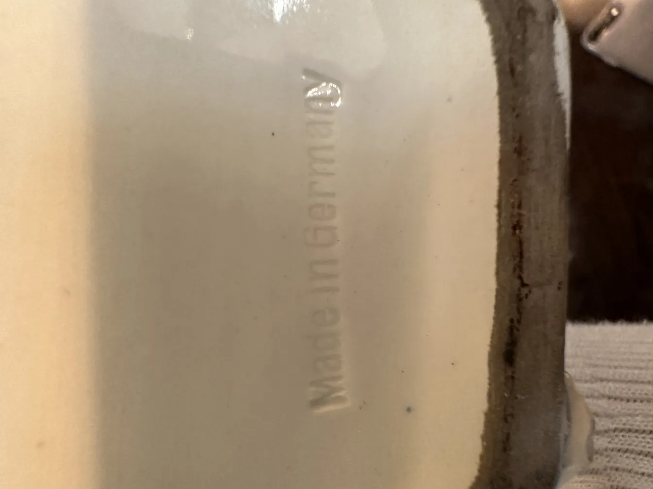 View of the bottom of an ancient european ceramic with a marking.