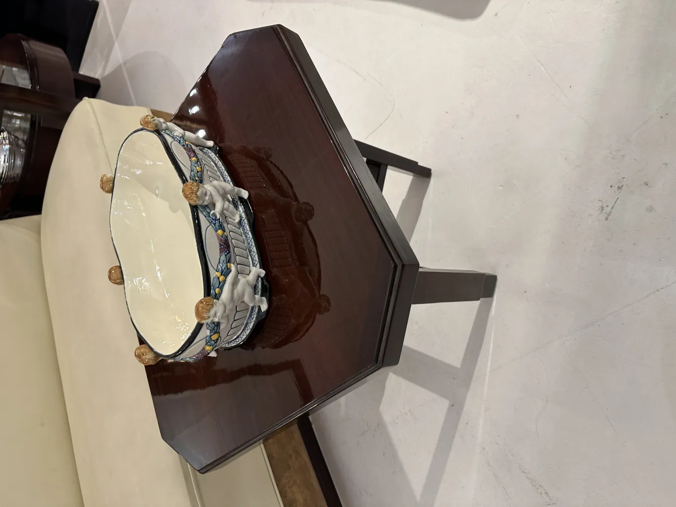 antique ceramic with vibrant colors and decorative figures on top, set in an elegant environment