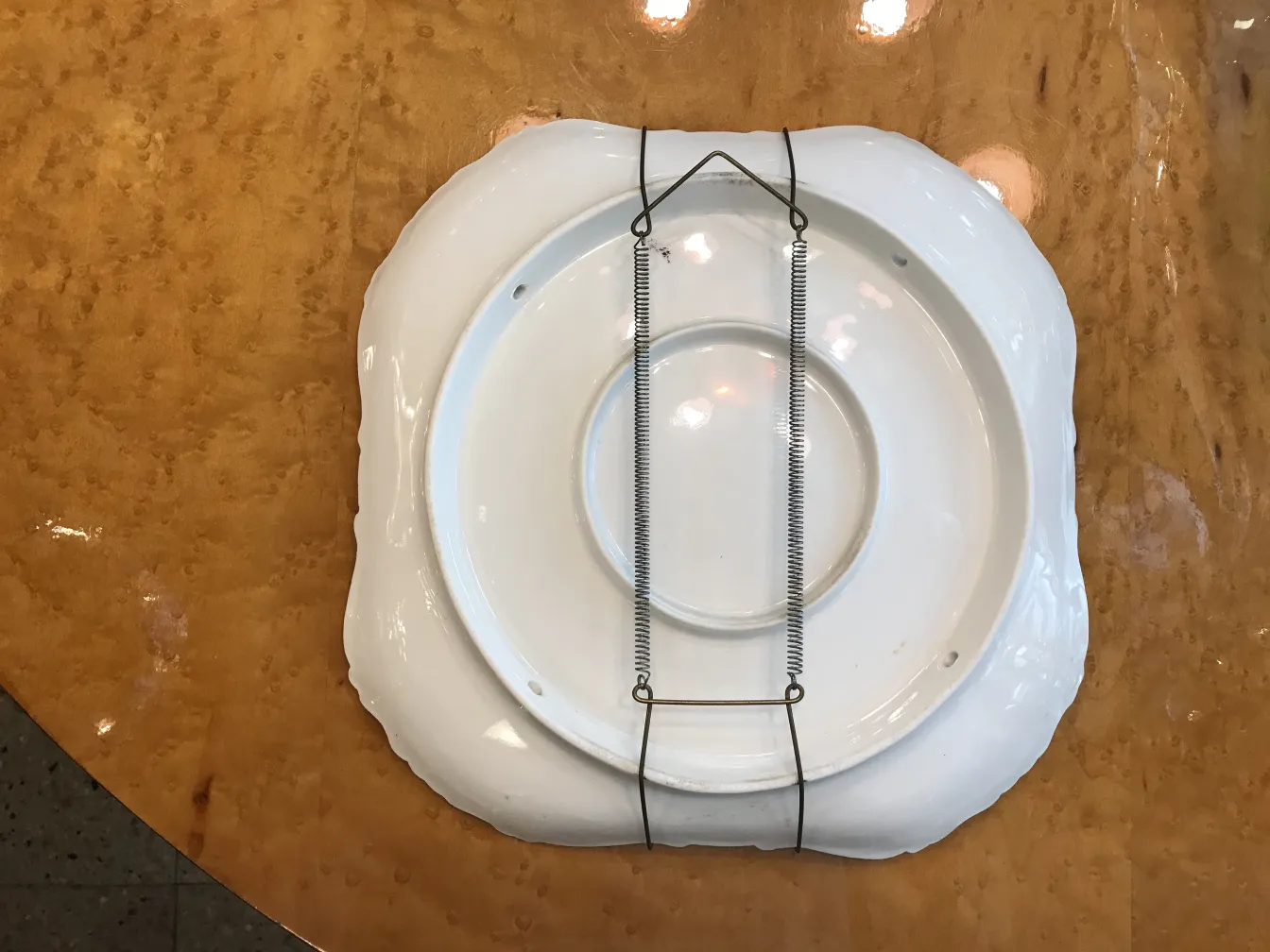 Antique white ceramic plate with wavy edge, hanging