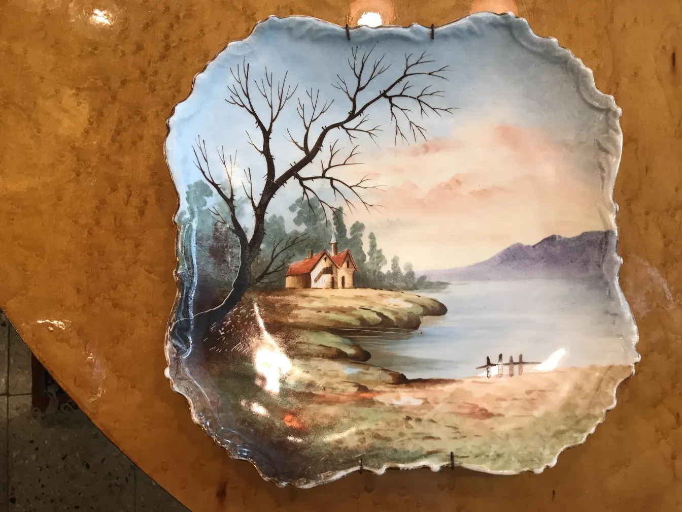 Antique ceramic plate with hand-painted landscape