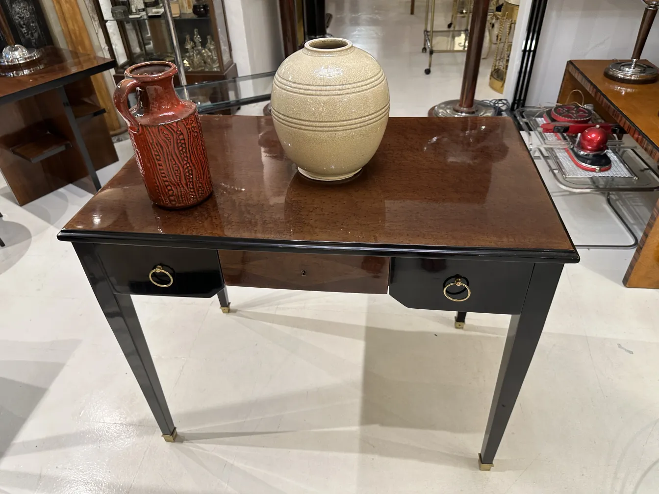 Antique ceramic vase on a polished wooden table.