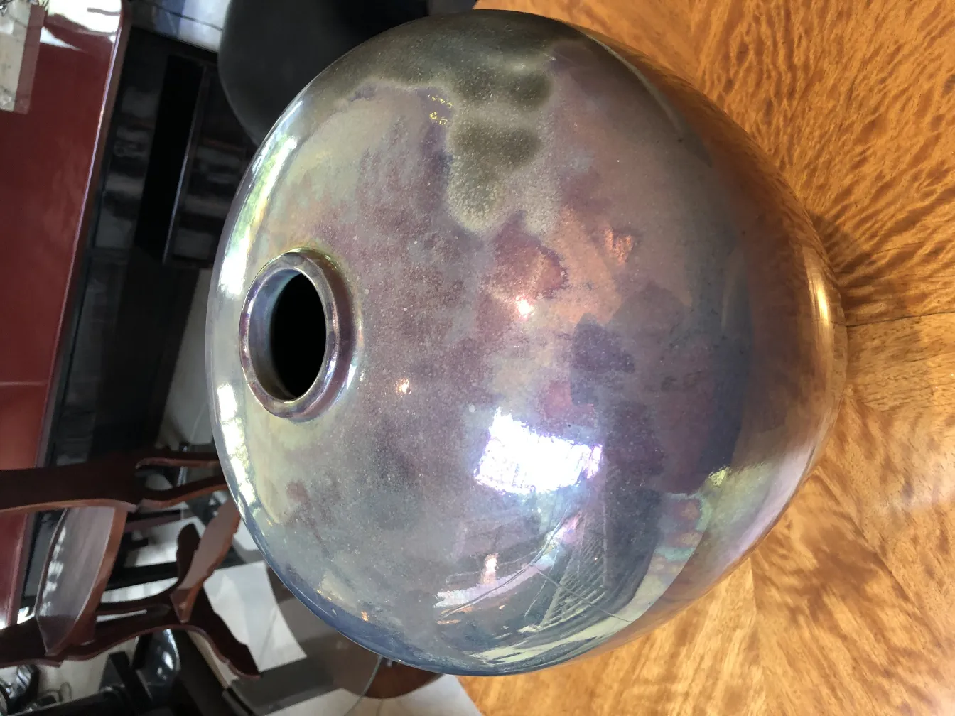 Antique spherical ceramic with glossy finish, wooden background