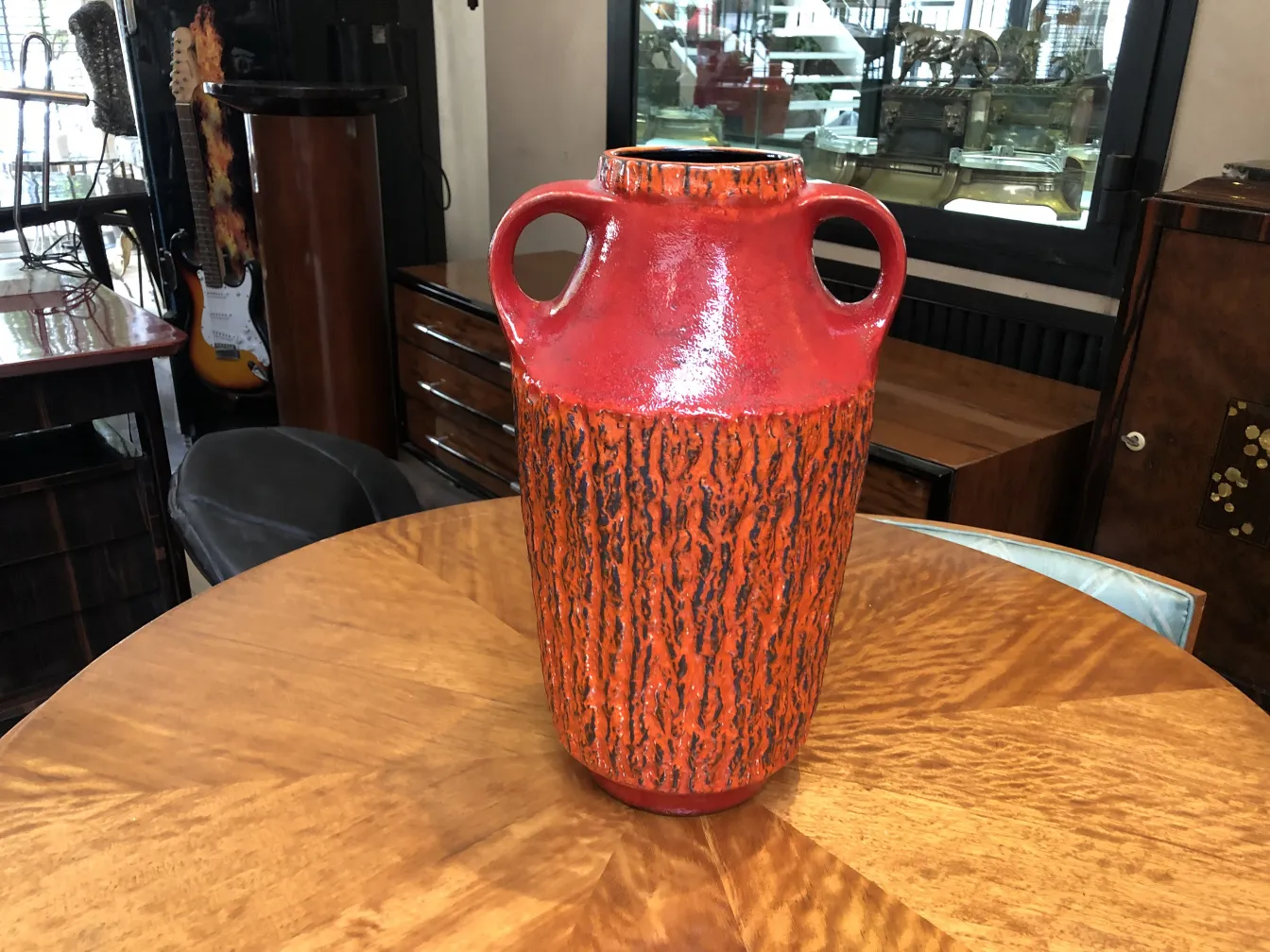 Antique ceramic vase in red and black with textures, decorative