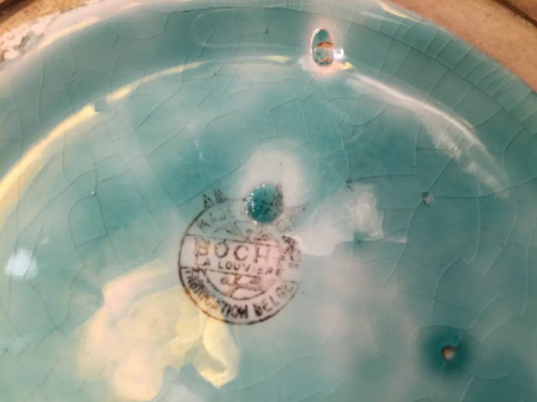 Antique ceramic plate with blue surface and marking