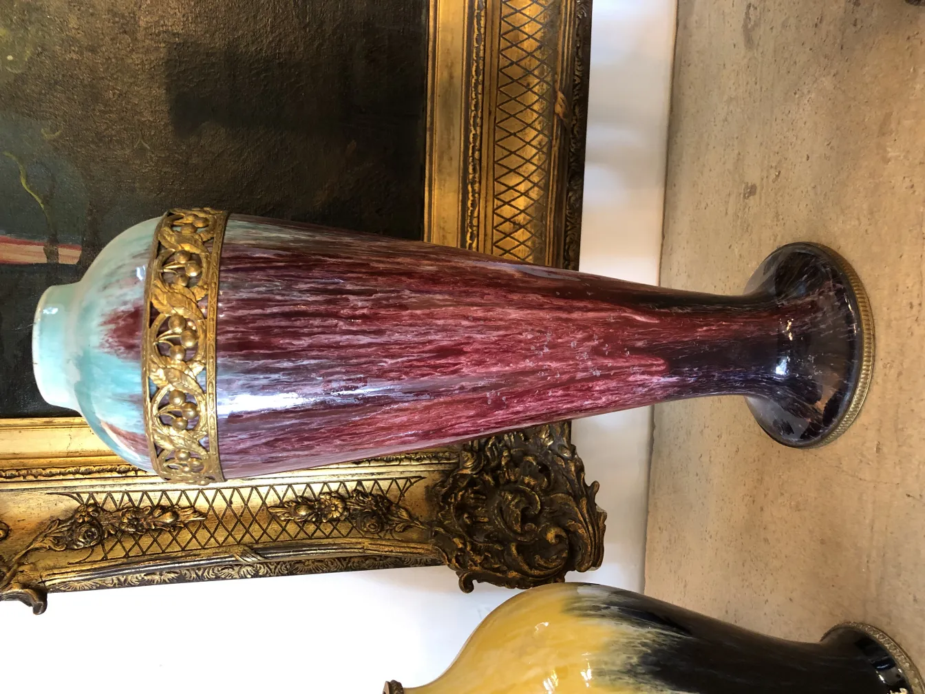 Antique ceramic vase featuring red and green hues with a golden trim.