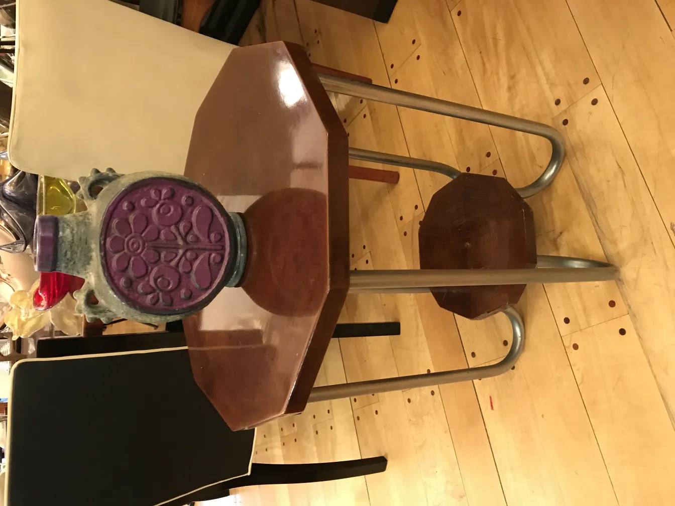 Antique ceramic with floral design and colorful accents on a table.