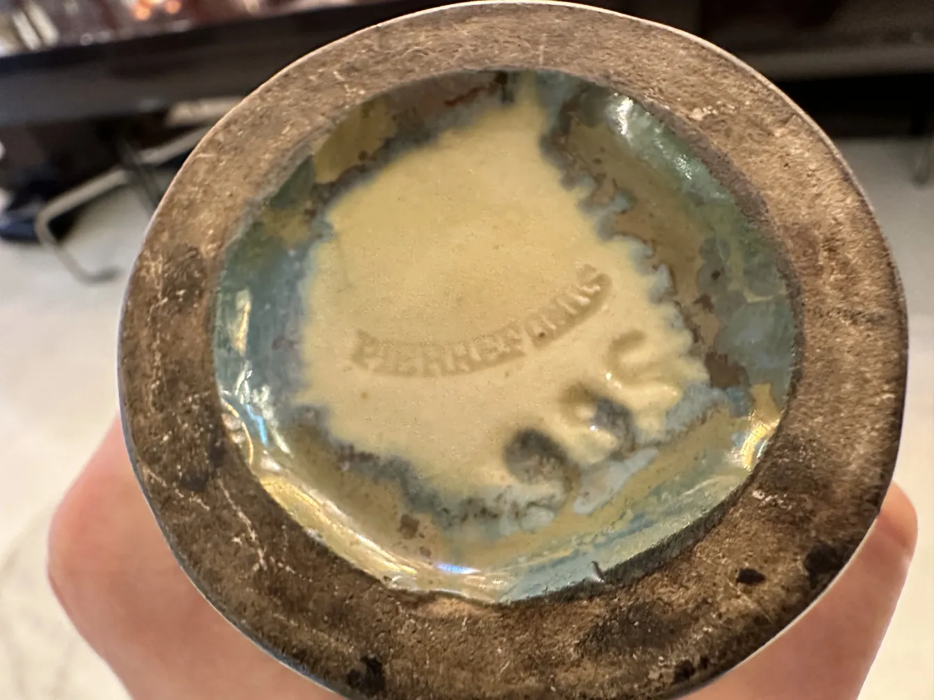 Base of antique ceramic with blue and beige details.