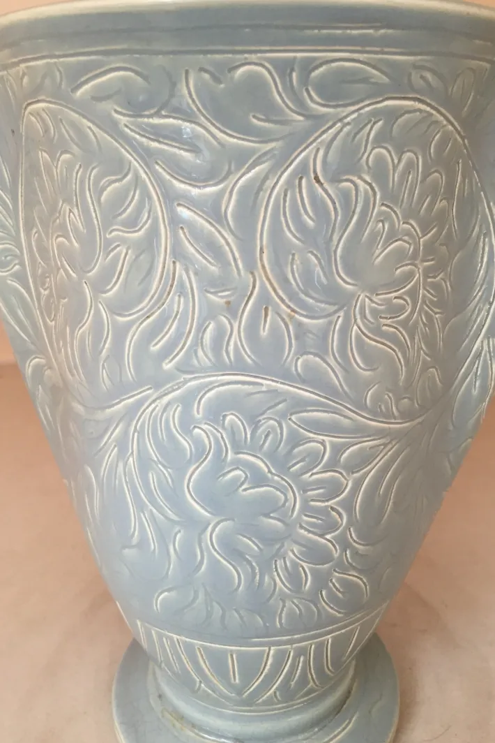 Antique ceramic vase with floral relief in blue