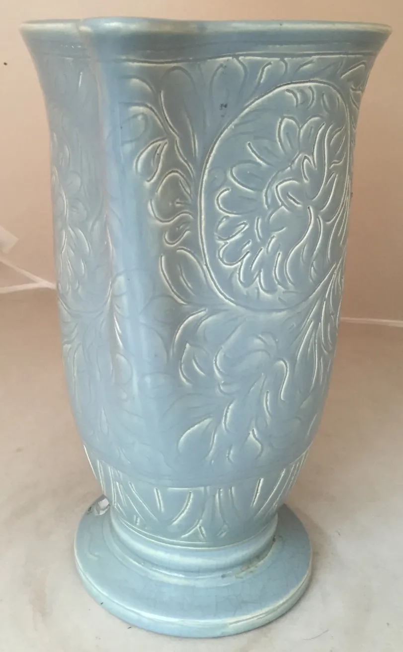 Antique blue ceramic vase with raised floral design