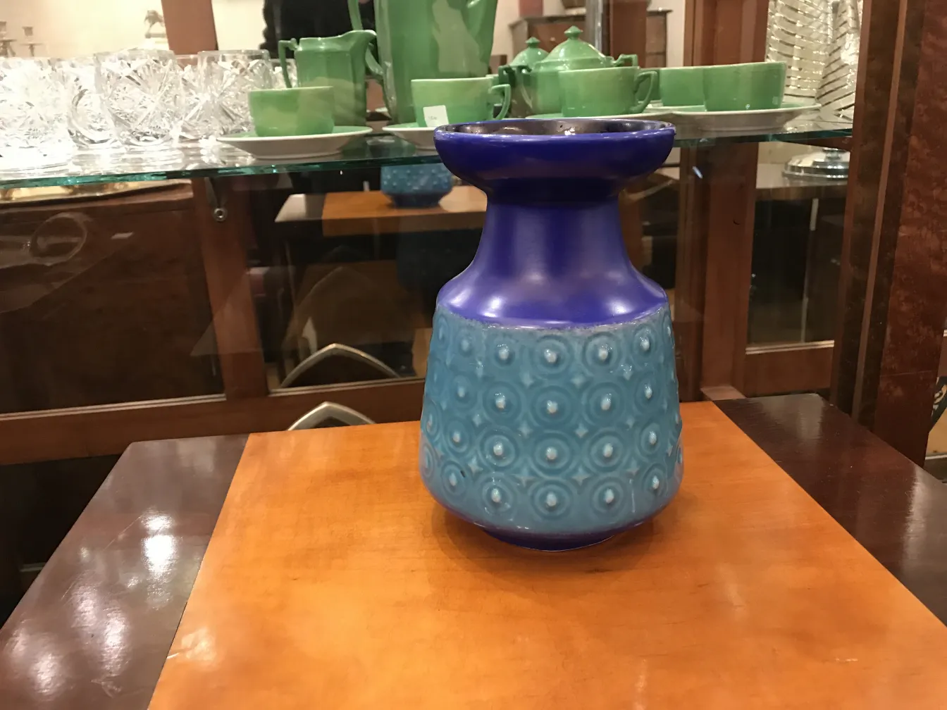 Antique ceramic vase with light and dark blue design, elegant background.