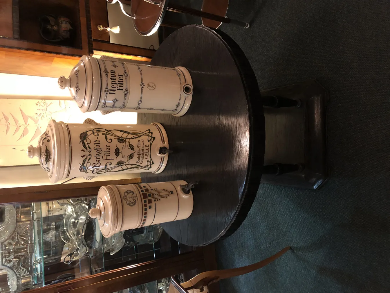 Three antique ceramic jars on a black table, decorated