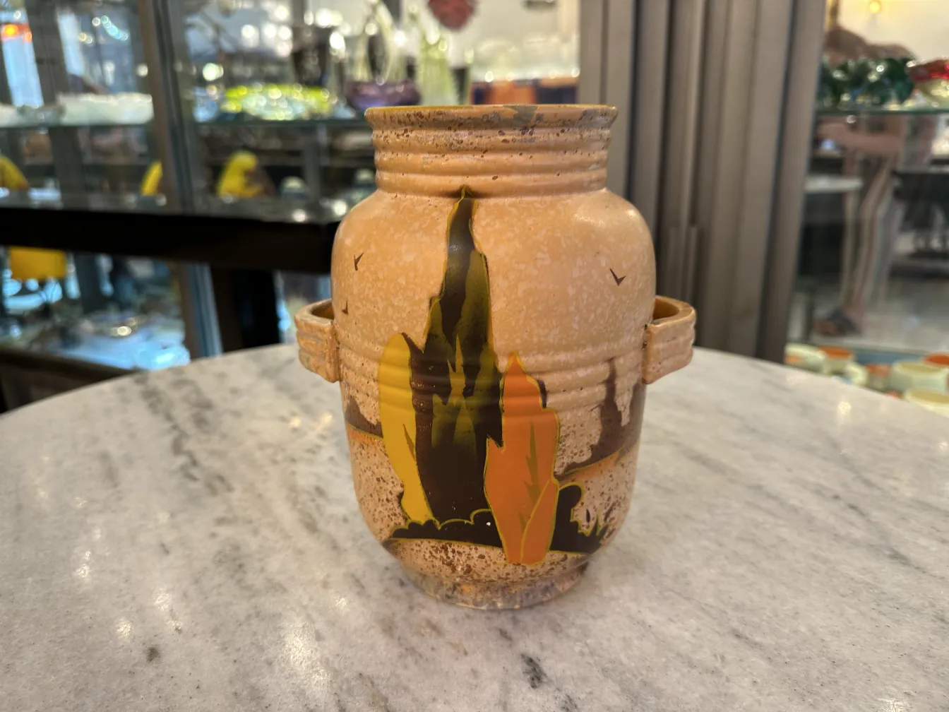 Antique ceramic vase with artistic yellow and black details, featuring abstract shapes. Antique atmosphere.