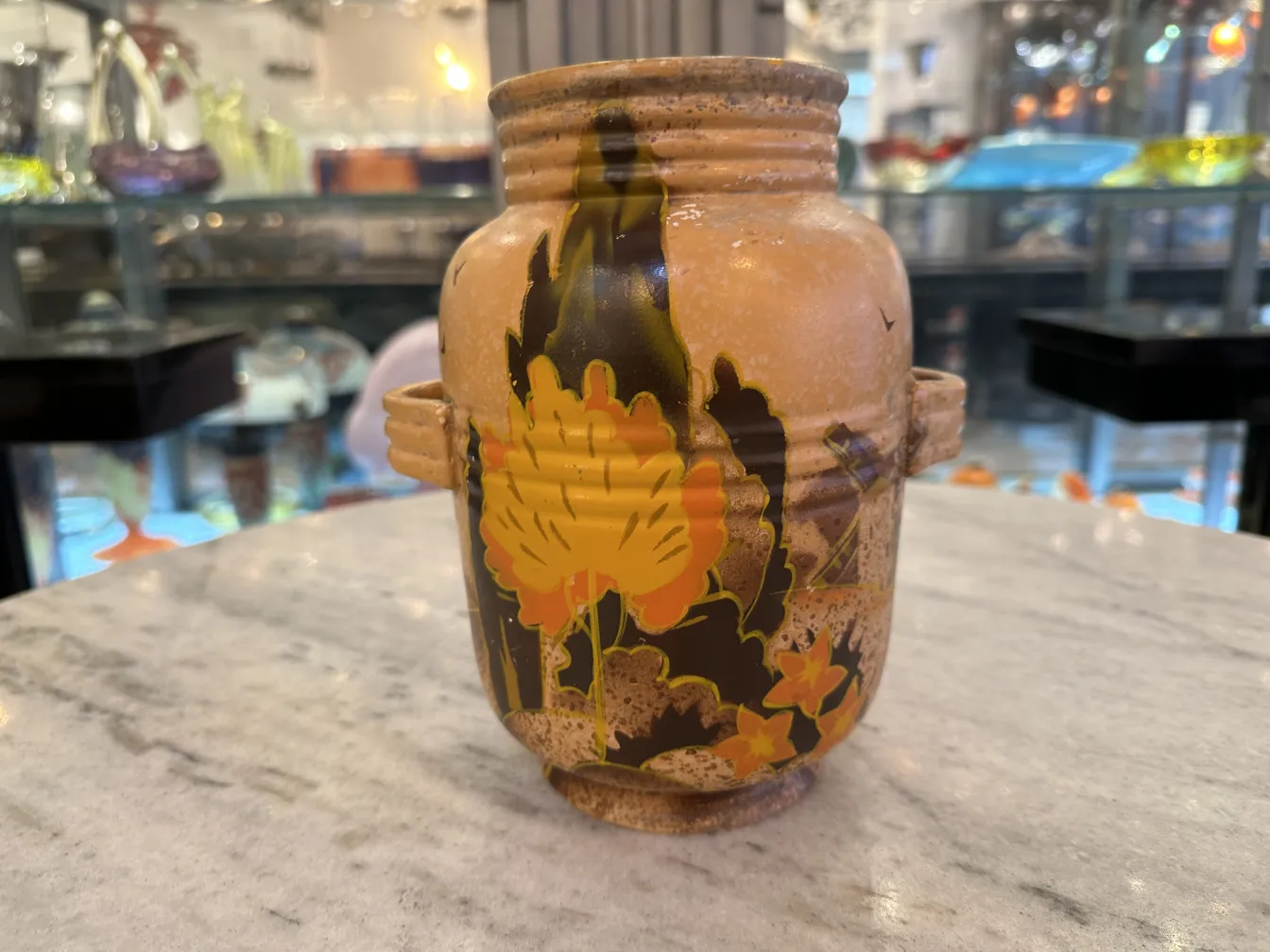 Old ceramic jar decorated with yellow flower design