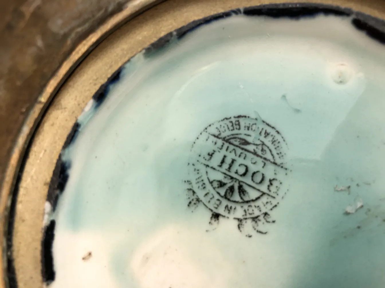 Decorative antique ceramic with distinctive seal, elegant setting.