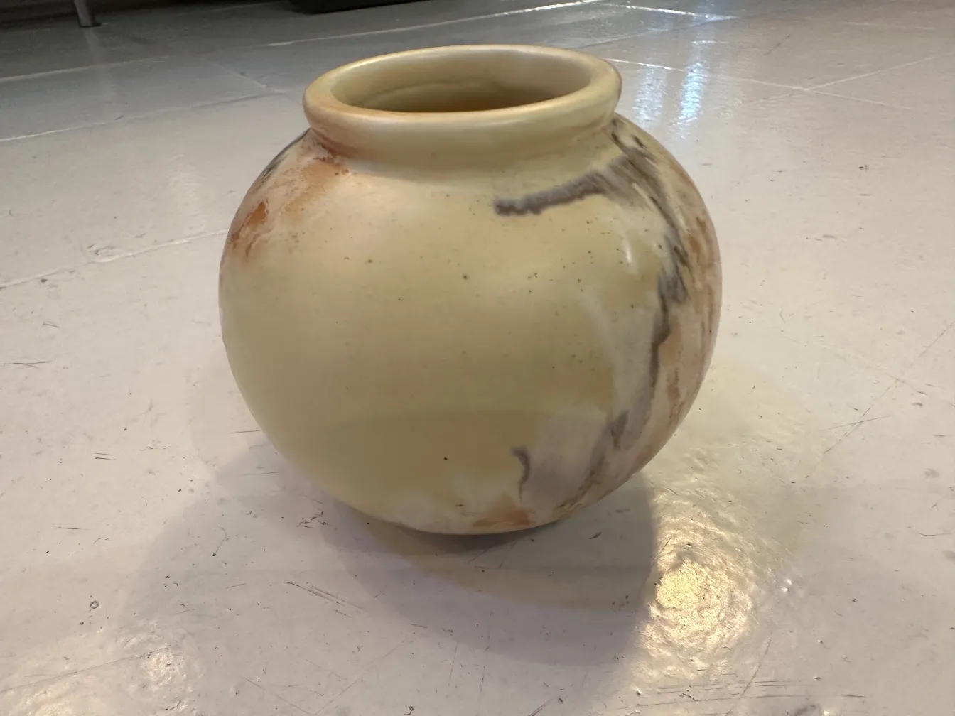 Antique ceramic vase with beige tones and dark details