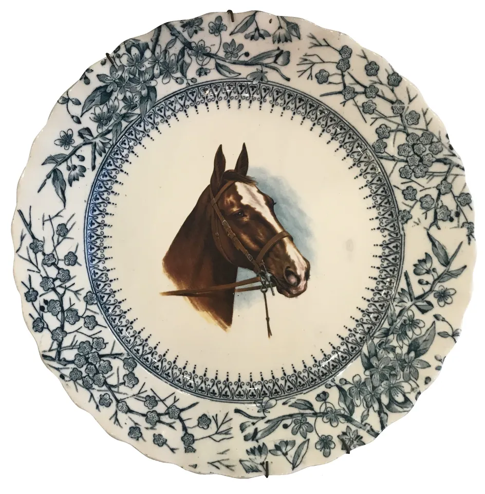 Antique ceramic plate featuring a horse and floral design