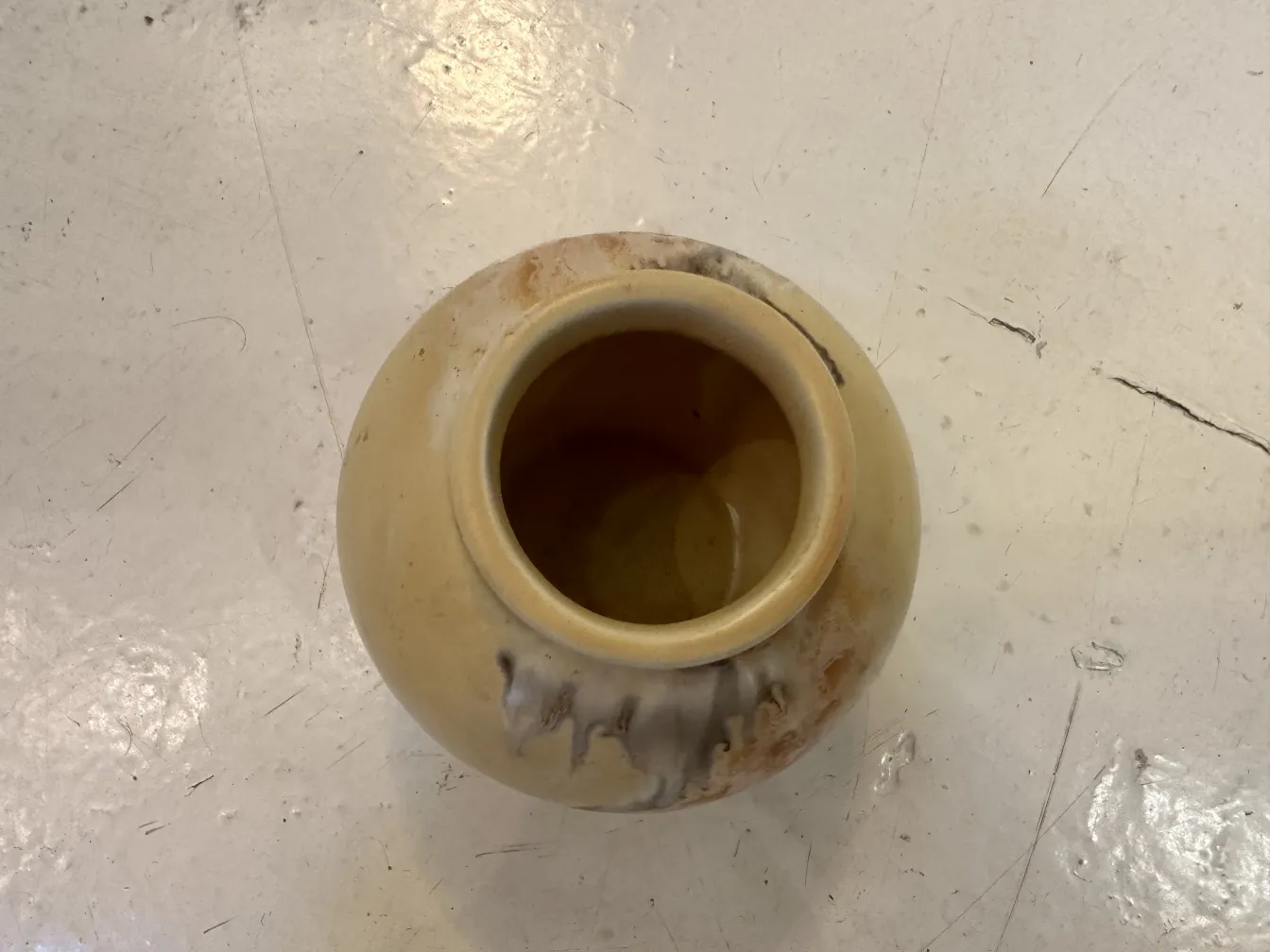 Antique ceramic vase with unique beige and brown finish, round shape.