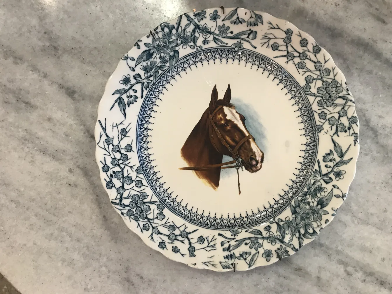 Antique ceramic plate featuring a horse design.