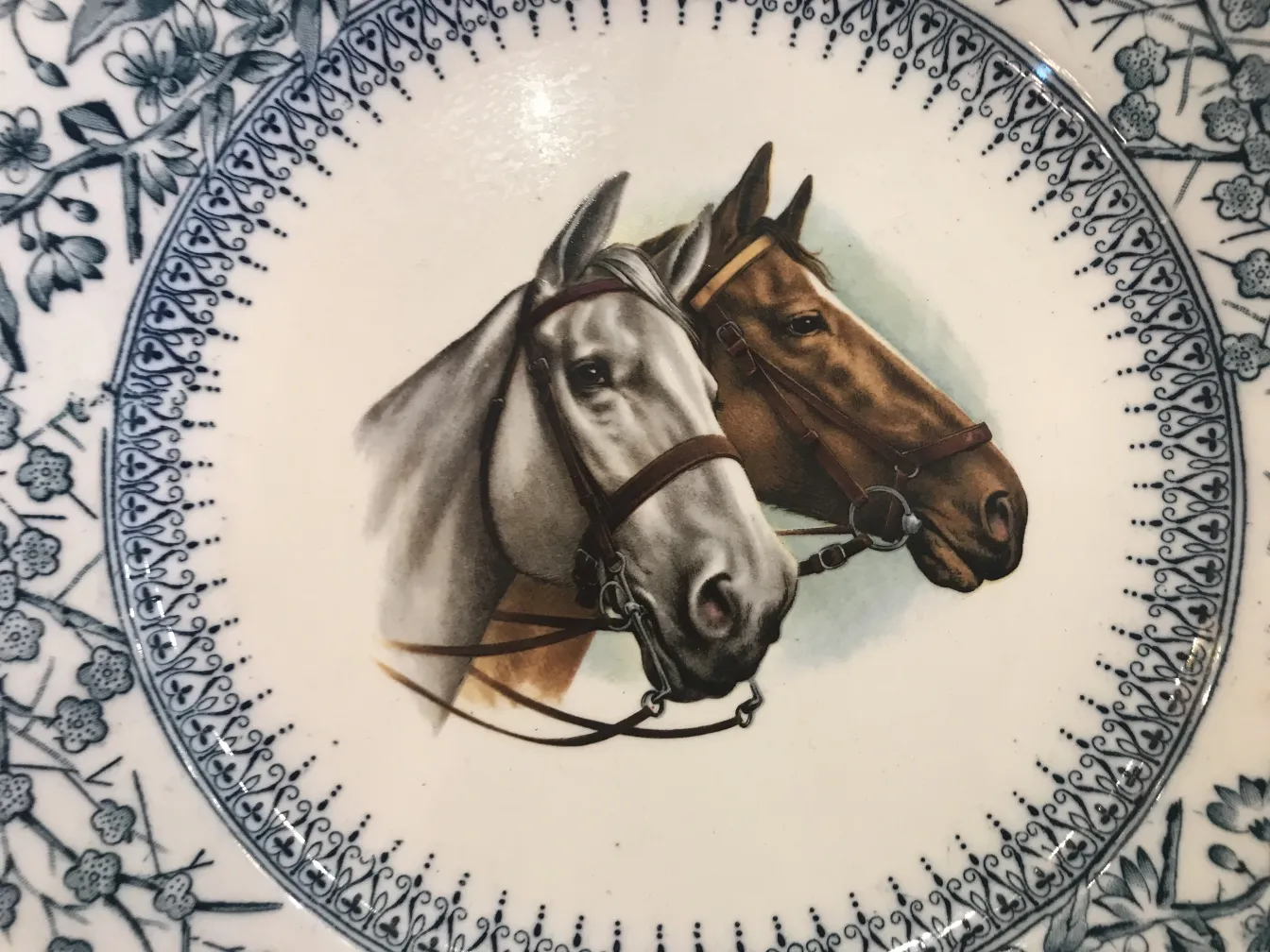 Antique ceramic plate featuring horse portraits