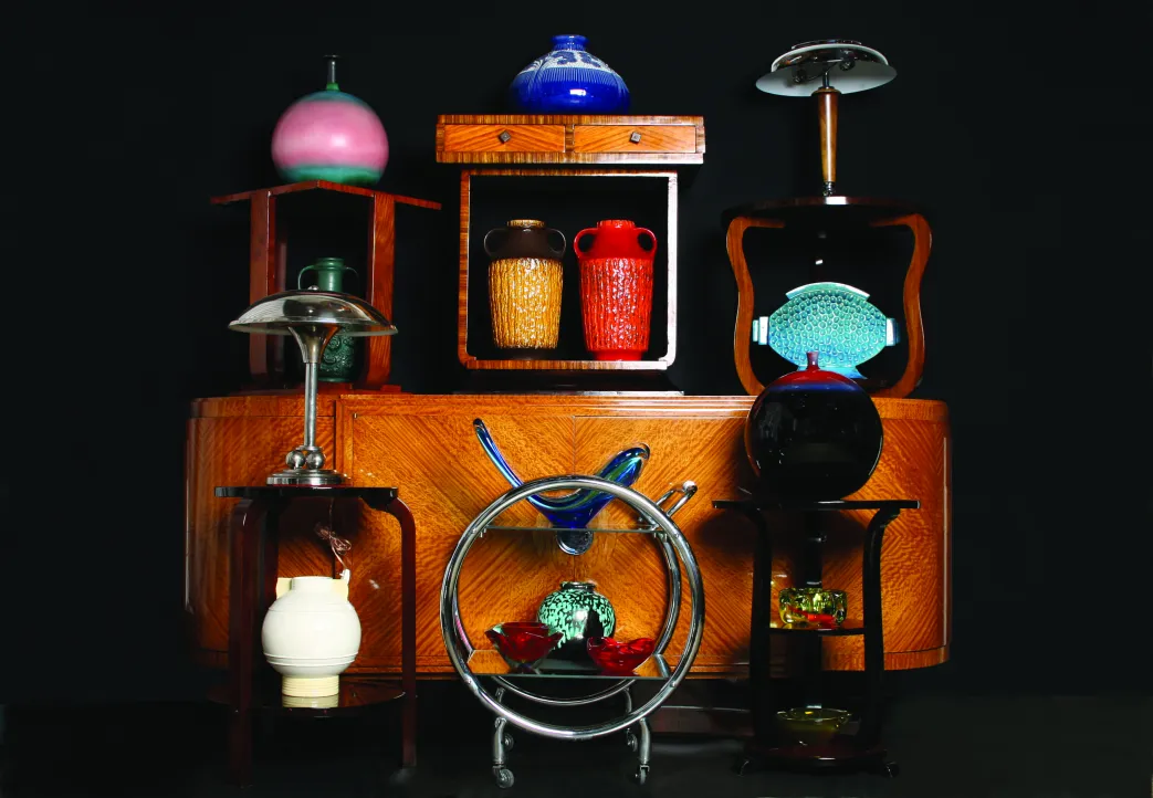 Collection of antique ceramics in varied colors and shapes.