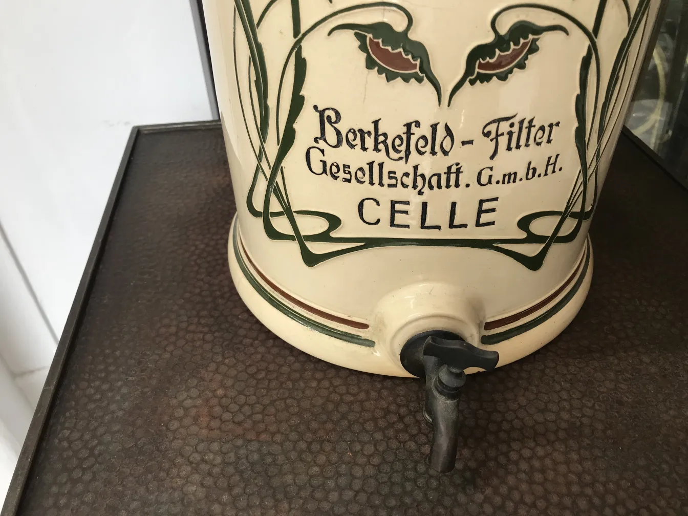 Antique ceramic jar from Berkefeld with floral design.