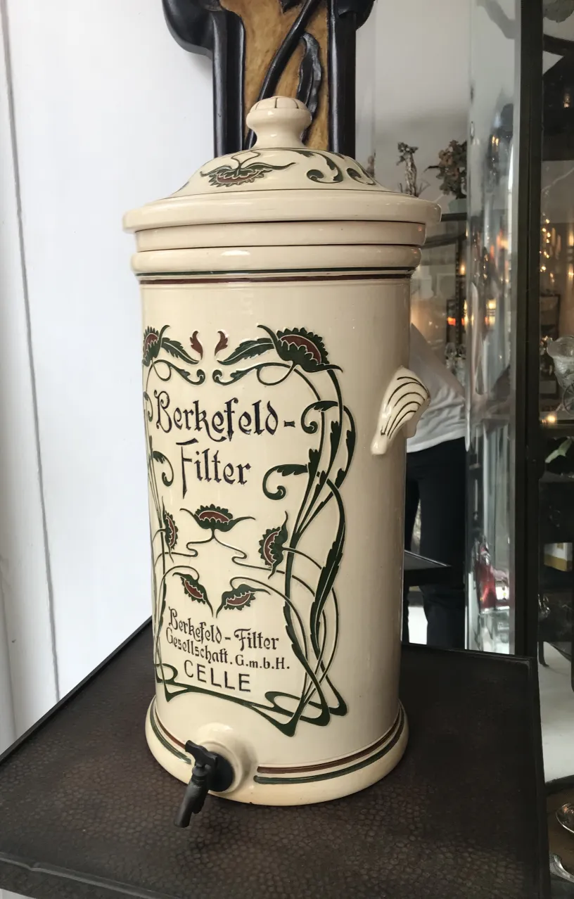 Antique ceramic jar with floral decoration in light tones. Classic atmosphere.