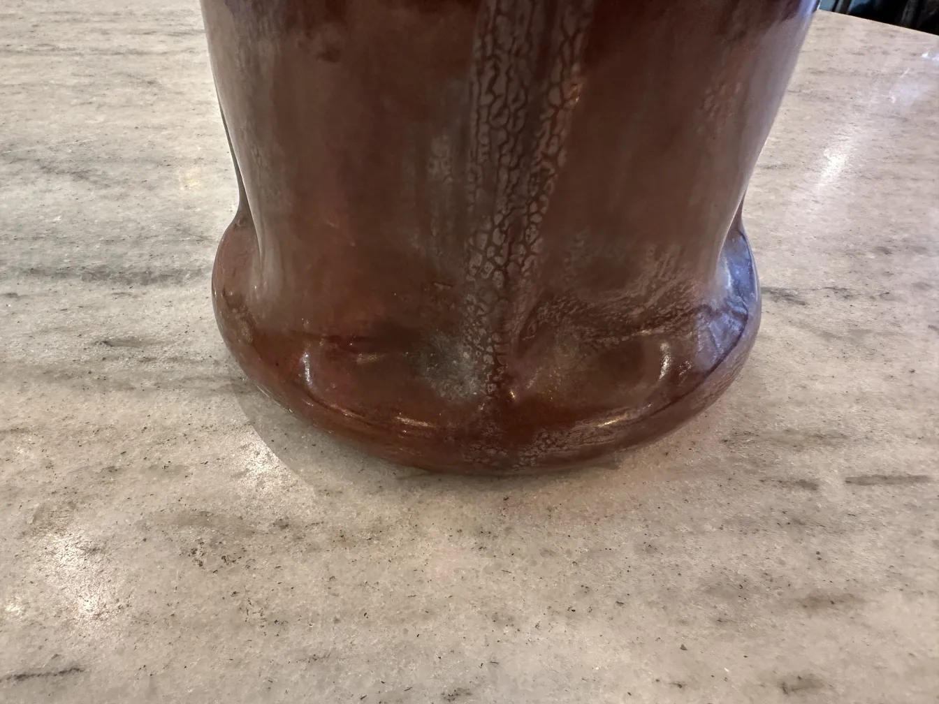Antique ceramic with unique design on stone table.