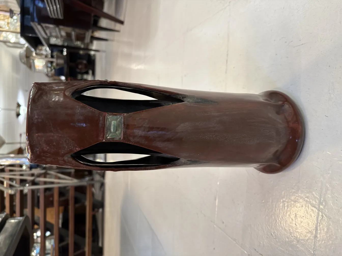 Antique ceramic vase with artisanal design and unique details in a classic setting.